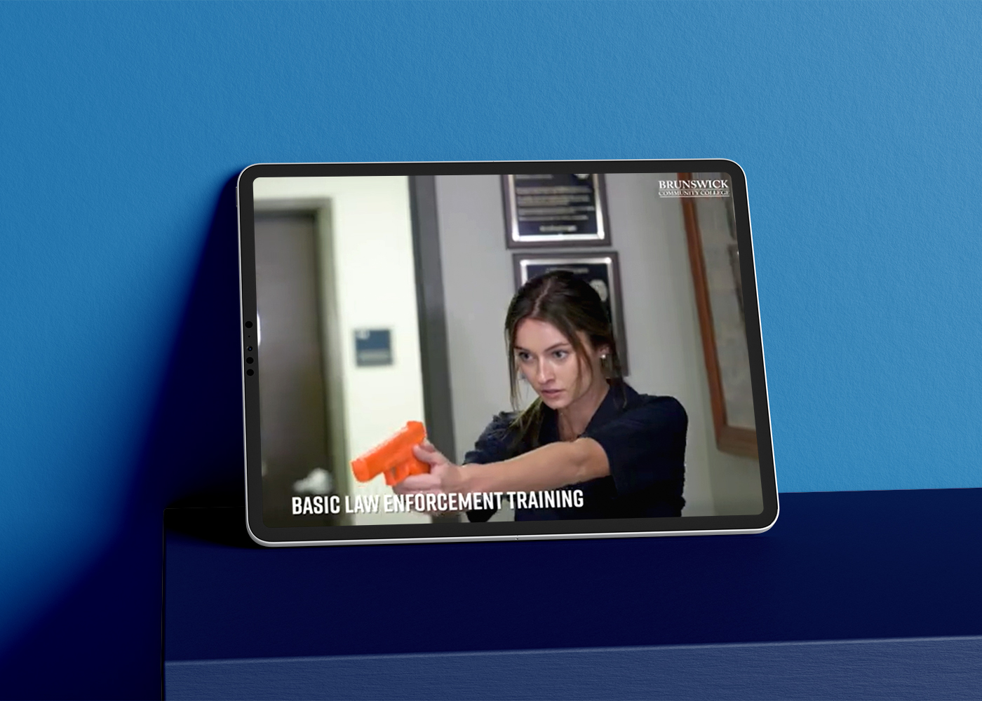 Tablet displaying Brunswick Community College criminal justice degree video